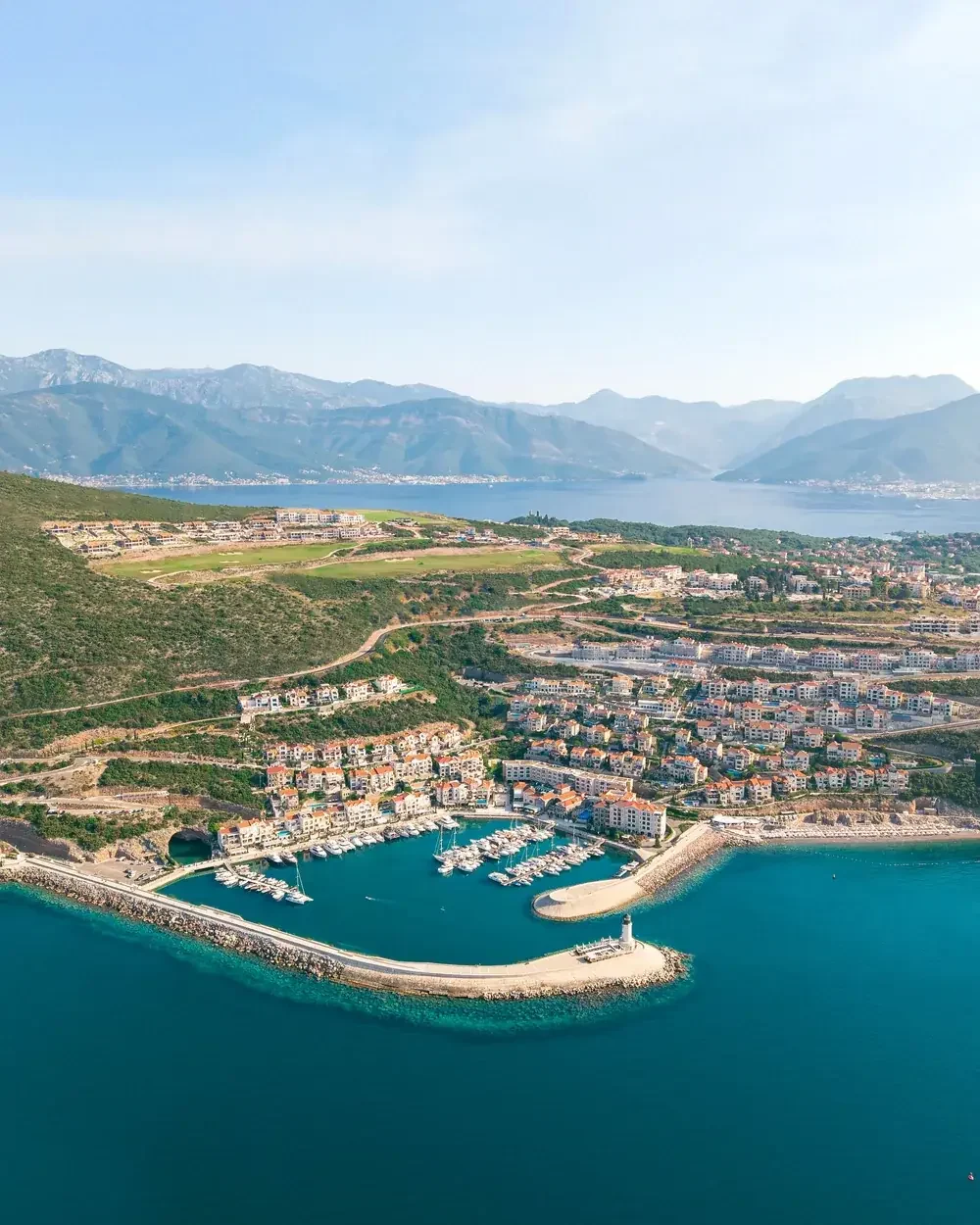 Aerial view of Luštica Bay marina, coastline and surrounding neighbourhoods